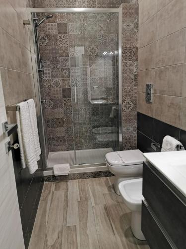 a bathroom with a shower and a toilet and a sink at B&B La Casa di Pino in Lampedusa