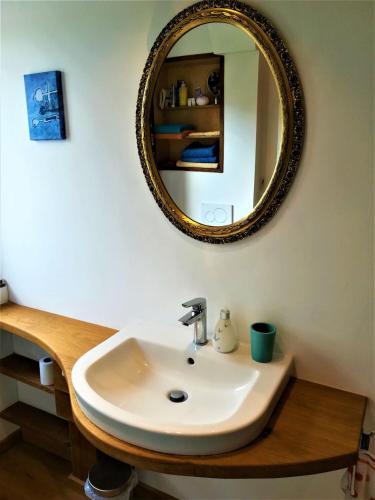 a bathroom with a sink and a mirror at Himmelreich - Über den Dächern der Altstadt in Witzenhausen