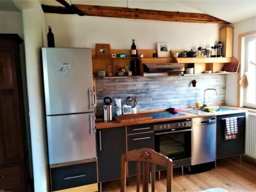 a kitchen with a stainless steel refrigerator and a stove at Himmelreich - Über den Dächern der Altstadt in Witzenhausen