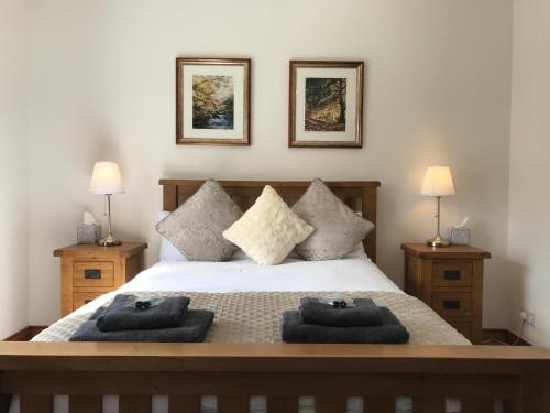 a bedroom with a large bed with two lamps at Craigs Rock Cottage Cookstown in Cookstown