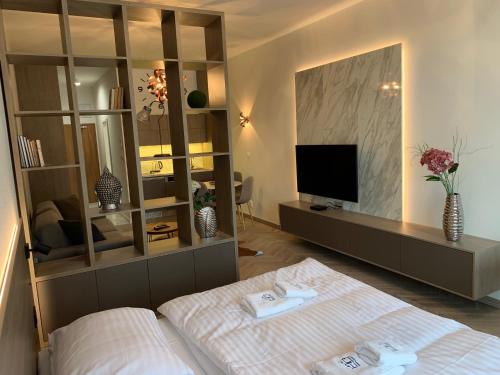 a bedroom with a bed and a large mirror at Hrebienok 2 Apartman D109 in Smokovce
