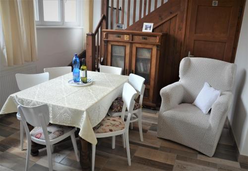 a dining room with a white table and chairs at Apartmány Pod vodárenskou věží in Poděbrady