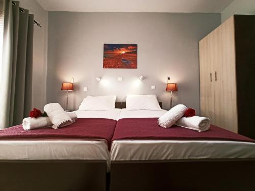 a bedroom with a large bed with two white pillows at Wave Marathias Apartments in Marathias