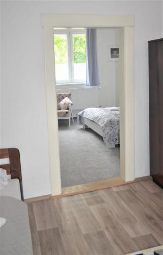 a bedroom with a bed and a mirror at Apartmány Pod vodárenskou věží in Poděbrady