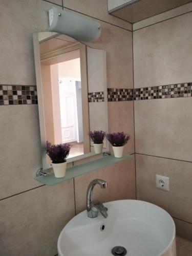 a bathroom with a sink and a mirror at LOUKIA'S HOUSE in Skala Kallirakhis