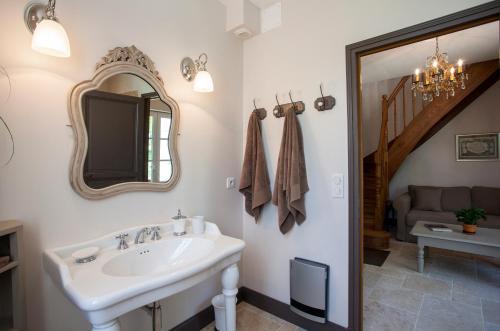 a bathroom with a sink and a mirror at Maison d'hôtes de Charme Les Bruhasses in Condom