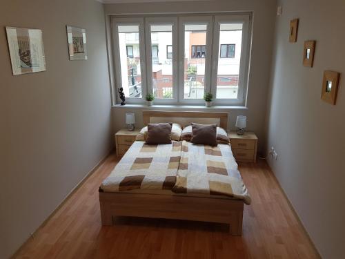 a bedroom with a bed and a large window at Apartament Karolina - Zielone Tarasy in Kołobrzeg