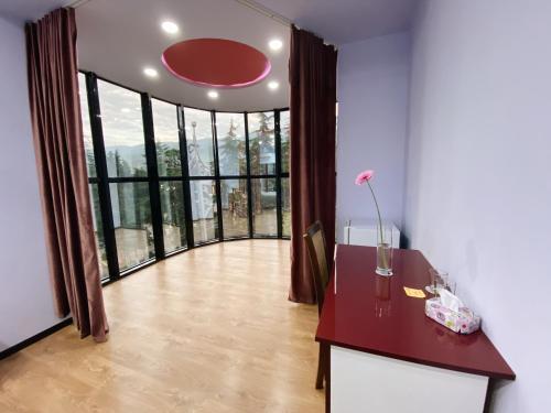 a room with a desk and a large window at Belleville in Ijevan