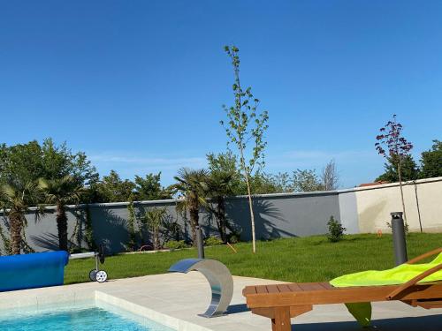 a swimming pool with a bench next to a fence at Villa Eni Medulin Sisan heated pool in Šišan
