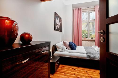 a small bedroom with a small bed and a window at Apartament Nowa 12 in Wrocław