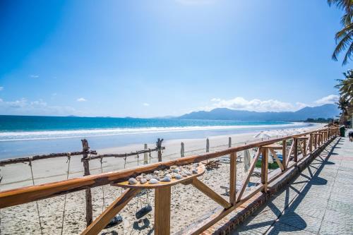 a boardwalk on a beach with rocks on it at Paradise Resort Doc Let - All Inclusive in Doc Let