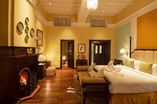 a hotel room with a bed and a fireplace at Savoy - IHCL SeleQtions in Ooty