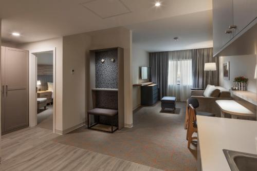 a living room with a couch and a table in a room at Holiday Inn & Suites - Aguascalientes by IHG in Aguascalientes