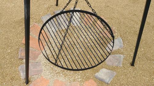 a wire basket sitting on top of some rocks at Sielanówek - Orzechowa Chatka z sauną wanną termalną jacuzzi in Żywiec
