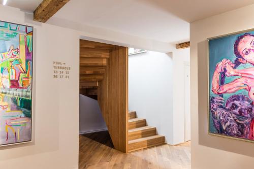 a hallway with a staircase and a painting on the wall at Kai 36 - Hotel zwischen Fels und Fluss in Graz