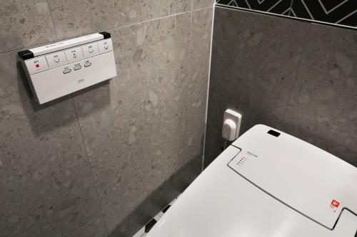 a control panel in a bathroom with a toilet at El Tower Hotel in Gunsan