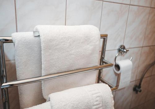 a group of towels on a towel rack in a bathroom at Penzion Pri Parku in Trenčín