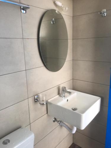 a bathroom with a sink and a mirror at Traditional House of Diafani in Karpathos Town