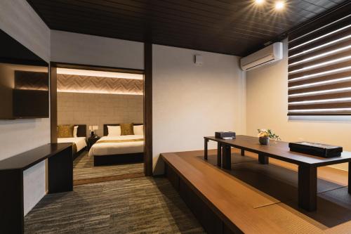 a living room with a bed and a table at GRAND BASE Crane in Fukuoka
