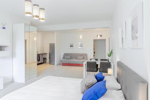 a bedroom with a bed and a living room at ATLAS UNIRII: Upscale Flats in the Heart of Bucharest! in Bucharest