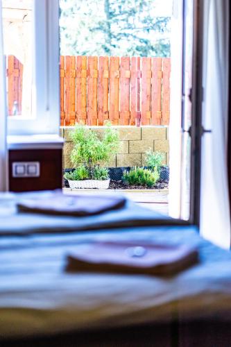 a bedroom with a bed and a window with a fence at Penzion Kera in Rossitz