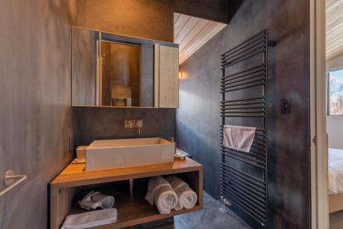 a bathroom with a sink and a mirror at Foxwood D in Niseko