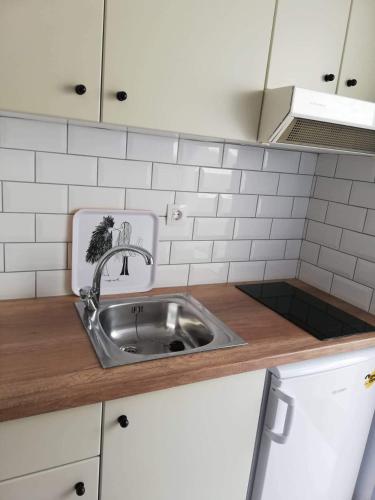 a kitchen counter with a sink in a kitchen at Marianna Studios in Aghios Petros Alonissos