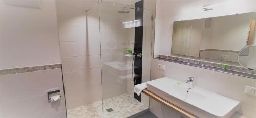a bathroom with a sink and a shower at Ferienhaus Wetterstein in Grainau