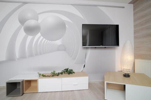 a living room with a tv on a wall at Design-Ferienwohnungen Stadtidyll in Wernigerode