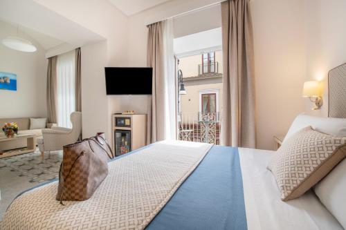 a hotel room with a bed and a fireplace at Maison Marie in Sorrento