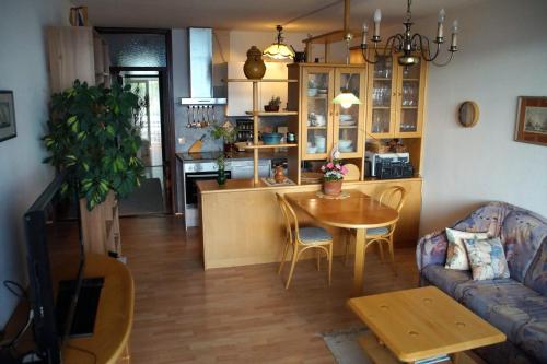 a living room with a table and a kitchen at Apartment im Hocheck in Altmünster