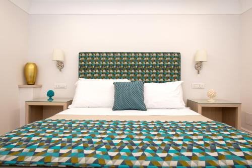 a bedroom with a large bed with a colorful bedspread at Maison Marie in Sorrento