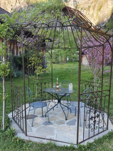 a table and chairs sitting under a gazebo at Le Relais Du Mont Blanc in Magland