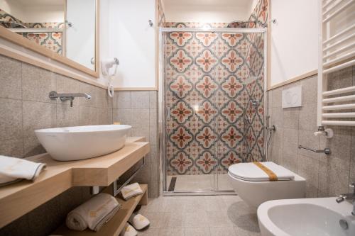 a bathroom with a sink and a toilet and a shower at Maison Marie in Sorrento