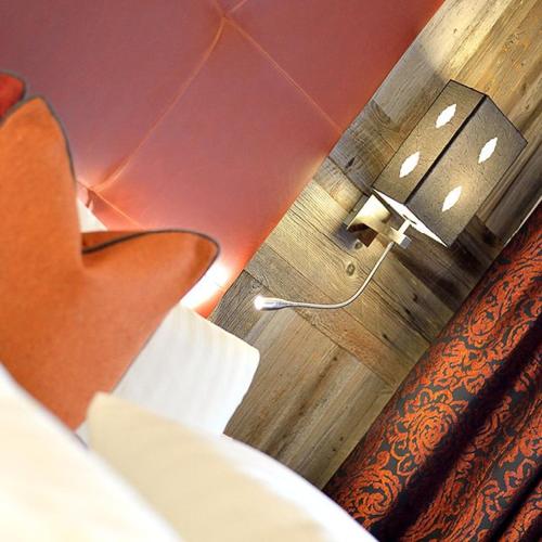 a seat on a train with a light on the wall at Alpenhotel Ischglerhof in Ischgl