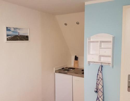 a kitchen with a sink and a stove in a room at Jäger`s Ferienwohnung an der Ostsee in Weitendorf