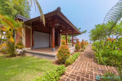 a house with a brick walkway in front of it at Villa Lumba Lumba - When perfection isn't enough! in Bubunan