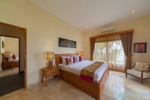 a bedroom with a large bed and a window at Villa Lumba Lumba - When perfection isn't enough! in Bubunan