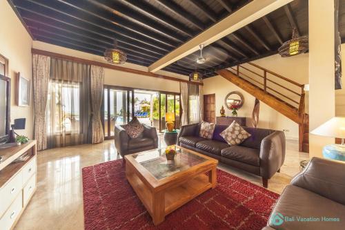 a living room with a couch and a coffee table at Villa Lumba Lumba - When perfection isn't enough! in Bubunan