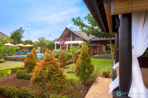 a view of a house with a garden and a pool at Villa Lumba Lumba - When perfection isn't enough! in Bubunan