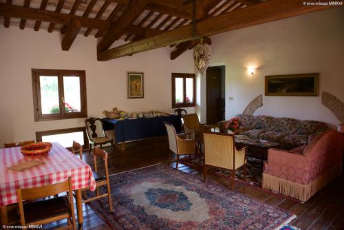 a living room with a couch and a table at Villa Mainardi Agriturismo in Camino al Tagliamento