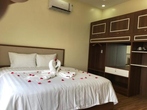 a bedroom with a bed with a stuffed animal on it at Winston Hotel Riverside in Ho Chi Minh City