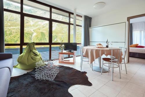 sala de estar con mesa y sofá en BASE CAMP alpine apartments, en Breuil-Cervinia