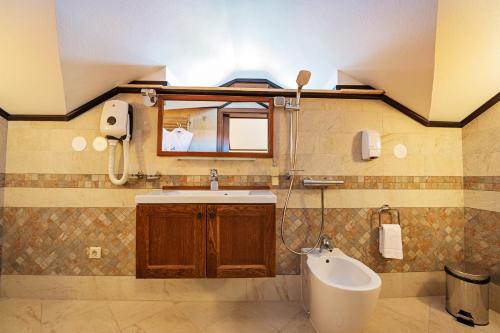 a bathroom with a sink and a mirror at 7 Pools SPA Boutique Hotel in Bansko