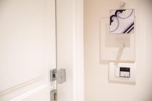 a door with a light switch and a sign on it at Maison Marie in Sorrento