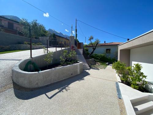 a concrete planter in front of a house at My Lake Apartments in Malcesine