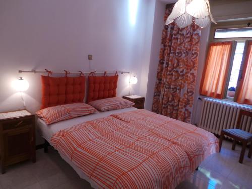 a bedroom with a red bed with two pillows at Villa Margherita - Rebomaholidays in Tignale