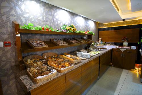 a counter filled with lots of different types of food at Hotel Istanbul Trend in Istanbul