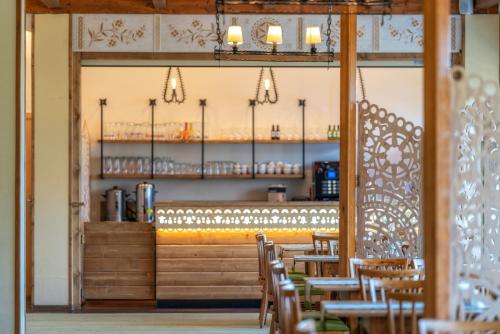 a dining room with chairs and a bar with lights at Hotel Górski Kalatówki in Zakopane