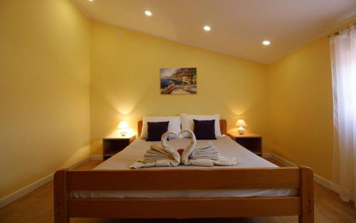 a bedroom with a bed with two towels on it at Apartments Klaric in Pirovac